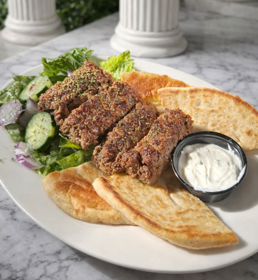 A kofta plate with grilled pita and tzatziki